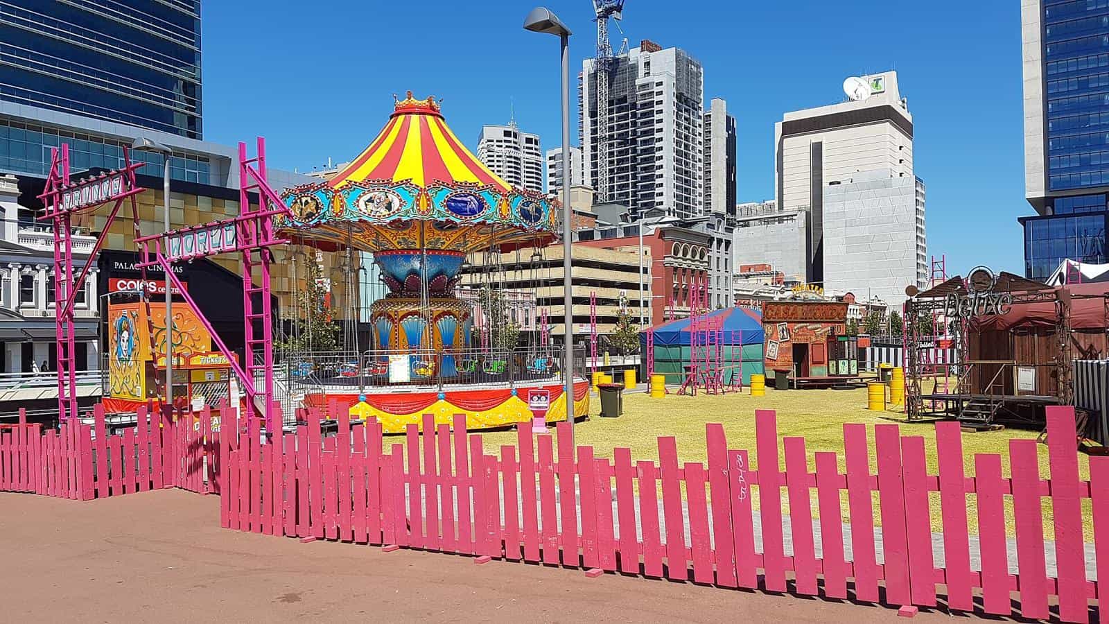 A colourful carousel and festival stalls set up in Yagan Square during Fringe World in Perth