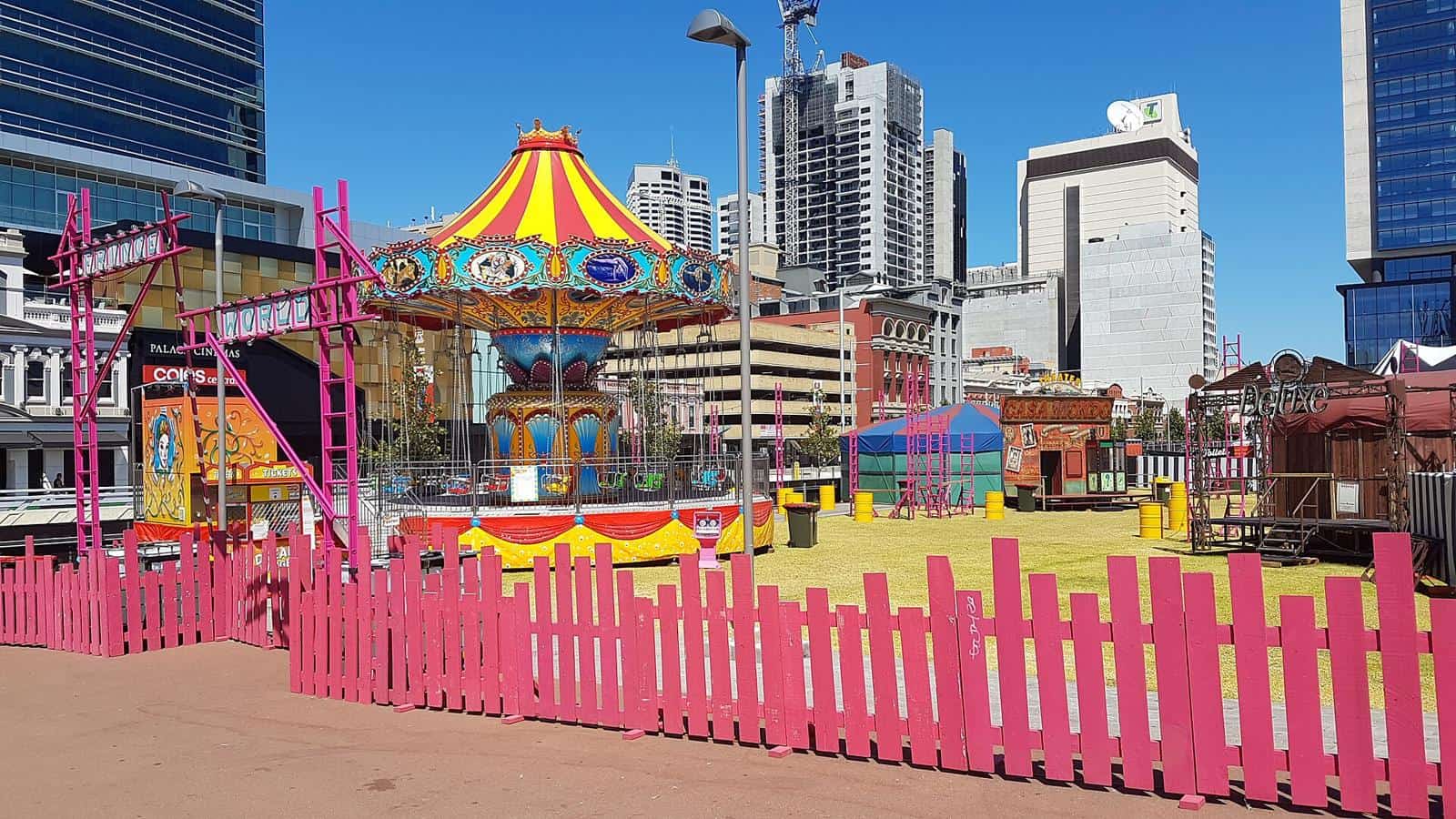 A colourful carousel and festival stalls set up in Yagan Square during Fringe World in Perth